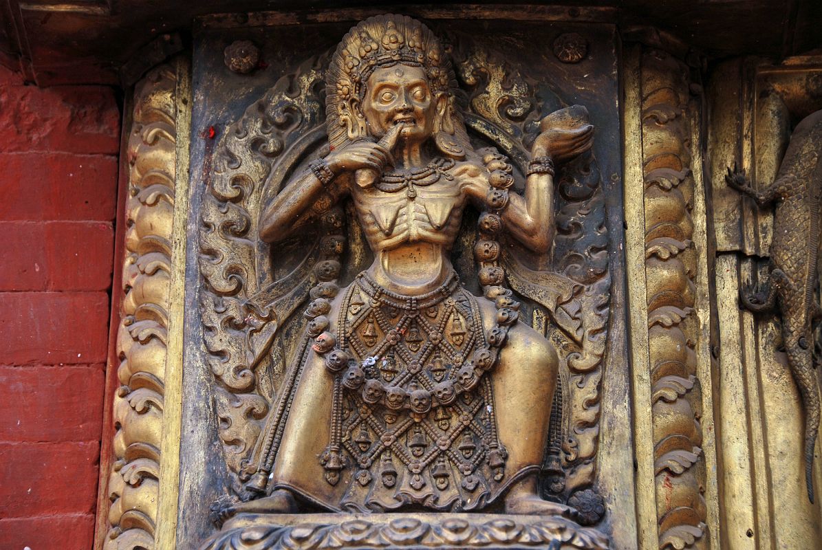 Kathmandu Bhaktapur 04-4 Bhaktapur Durbar Square Golden Gate Emaciated Deity Close Up An emaciated tantric deity flanks the door of the Golden Gate in Bhaktapur�s Durbar Square.